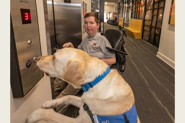 Dan Darkow and his service dog, Kizmet, use an elevator at Shriver Center.