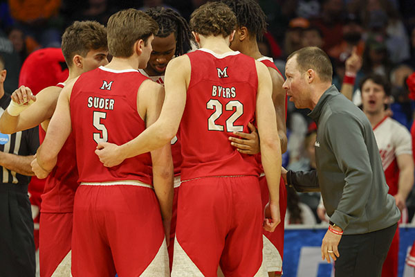 Travis Steele, right, with Miami men's basketball team