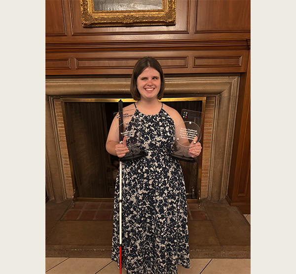 MaKenzie Love holds the awards after winning the national Braille Challenge in 2025 (photo courtesy of MaKenzie Love).