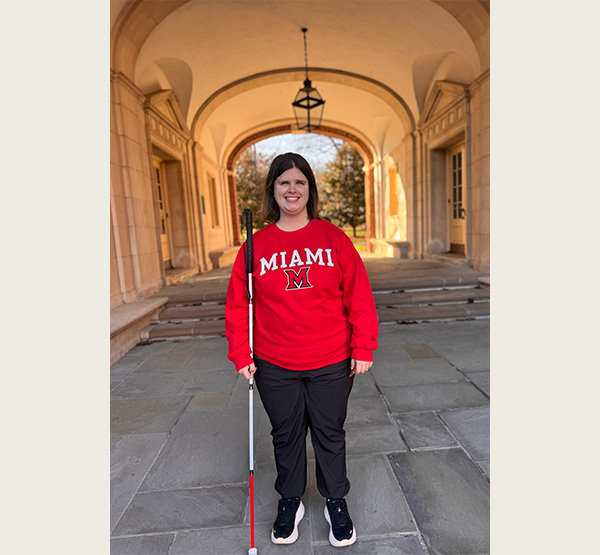 MaKenzie Love stands beneath Upham Arch at Miami University.