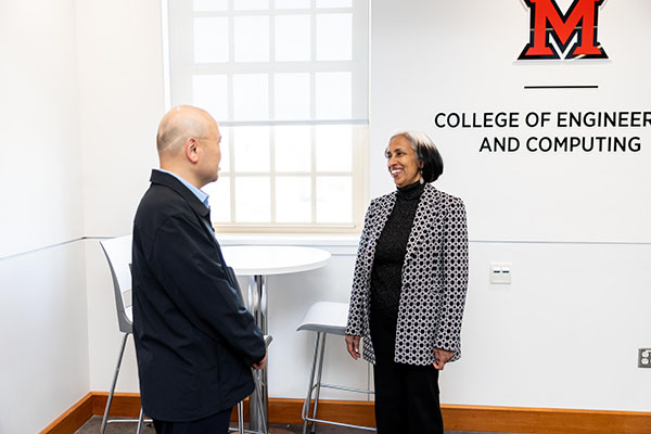 Beena Sukumaran, the Dinesh and Ila Paliwal Dean of the College of Engineering and Computing, right, talks with Liran Ma, chair of the Department of Computer Science and Software Engineering.