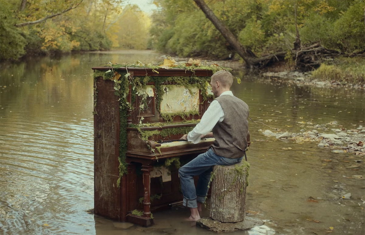 Jon Sanford, staff accompanist , plays the piano in Four Mile Creek . the piano is decorated with moss and other objects from nature