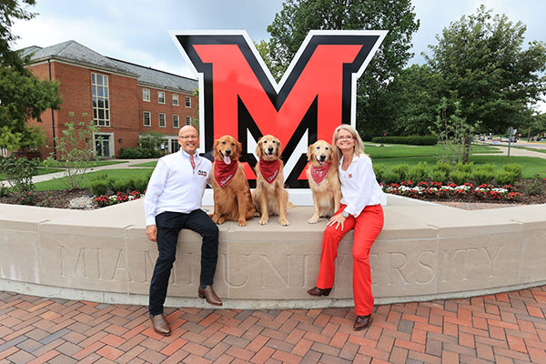 President Gregory Crawford and University Ambassador Dr. Renate Crawford with their dogs at RedHawk Plaza