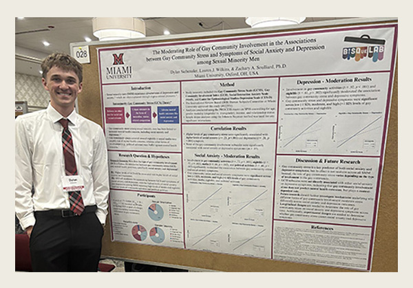 Dylan Siebenaler stands next to his poster at the undergraduate research forum