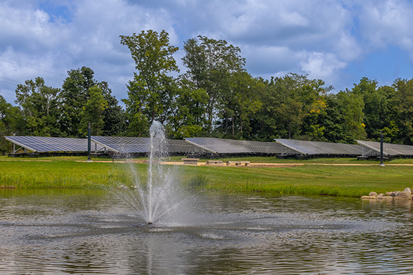 Western upper pond and fountain with a view of the Western Geothermal North Solar Arrays in the background