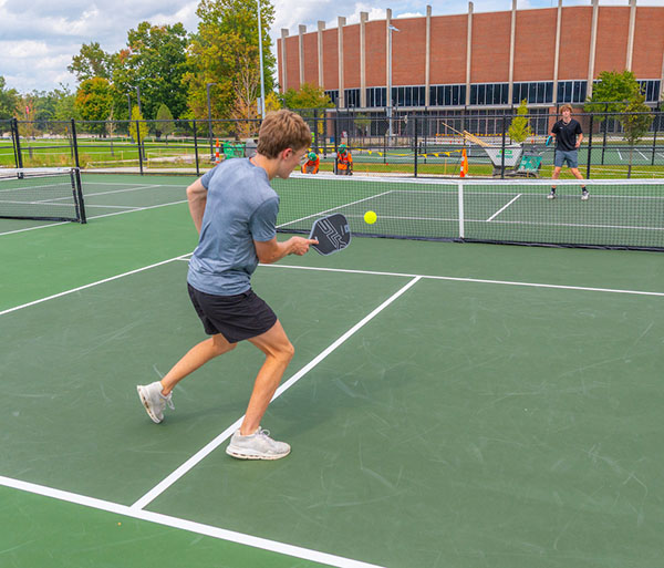 several students play pickleball at the new courts near Millett 