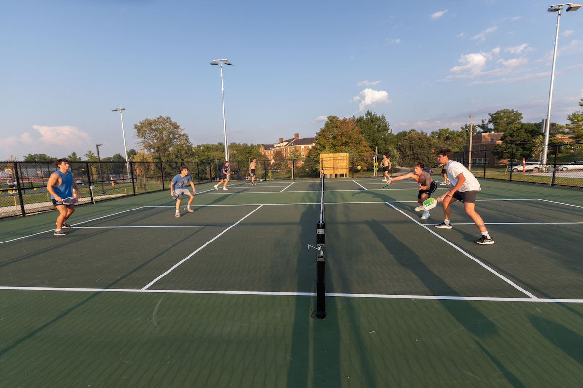 6 students play pickleball on the new courts at Millett lawn