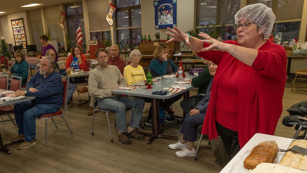 nancy parkinson speaks to residents attending monday meals