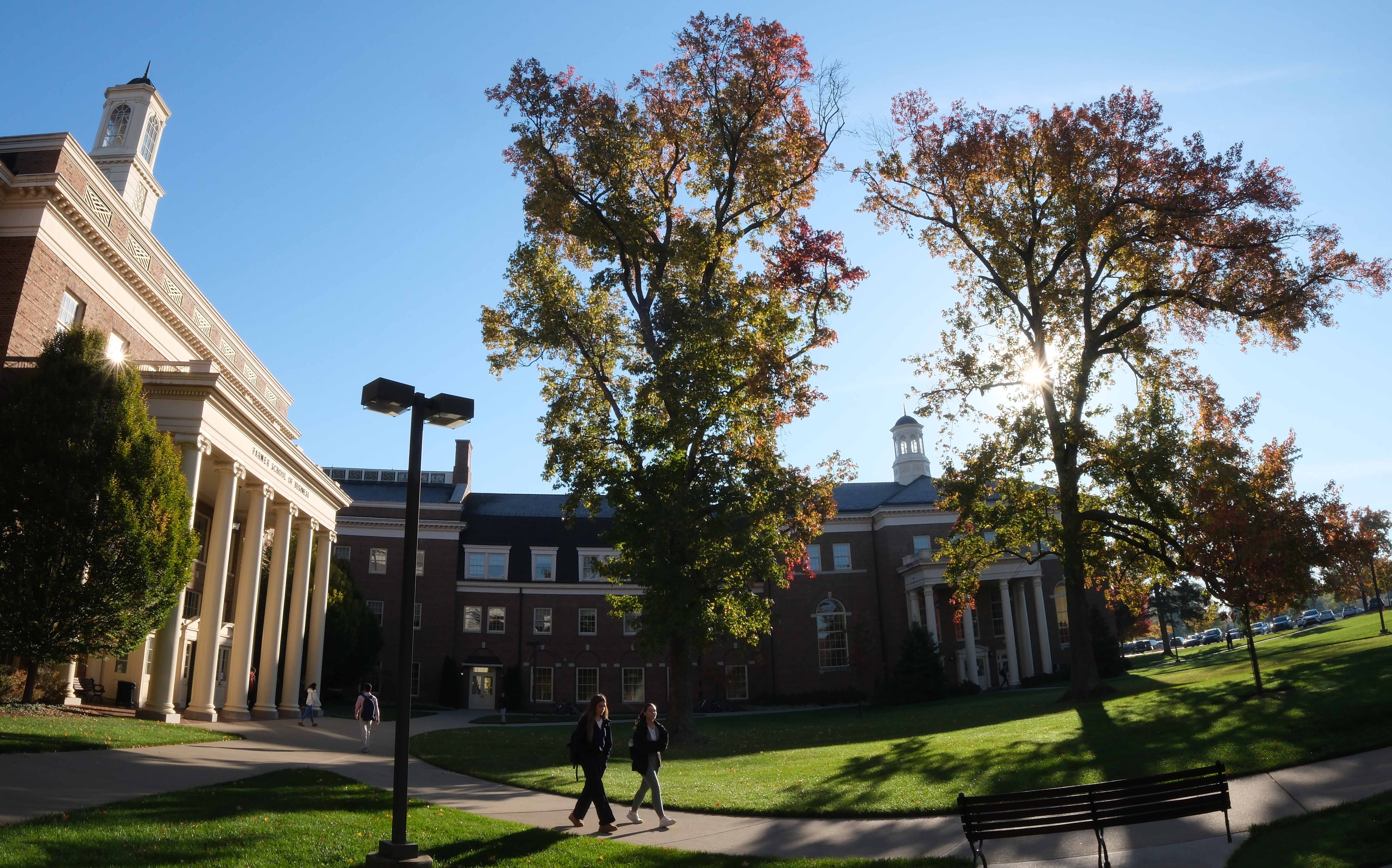 Farmer School in fall with students walking by