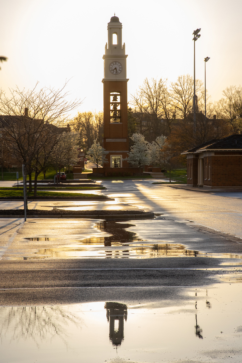 Reflections after the rainbow: Looking west toward the setting sun, the Pulley Tower is reflected in puddles in the Cook Field parking lot.