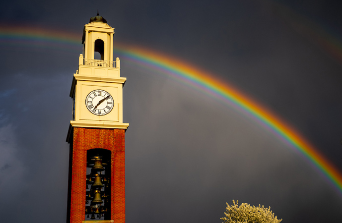 A rainbow centered over the Pulley Tower with dark clouds in the background.
