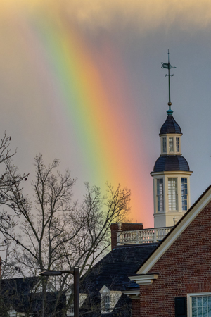 A single rainbow appears to end at the MacCracken Hall cupola.