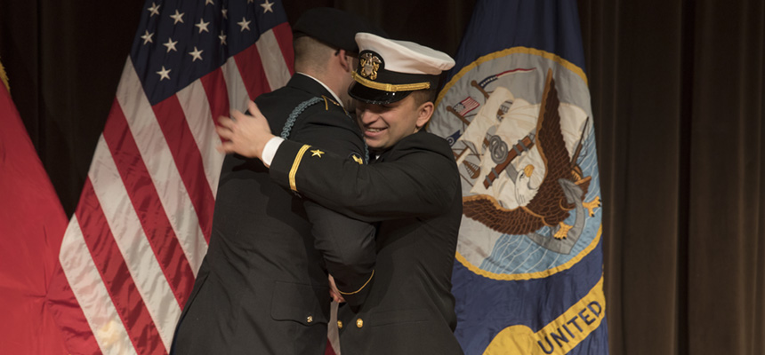 A ROTC student hugs an officer at commissioning.