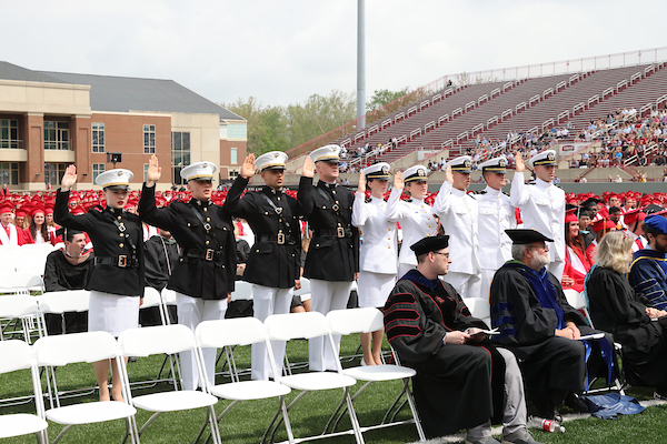 Cadets saluting at a ceremony at Yager Stadium.