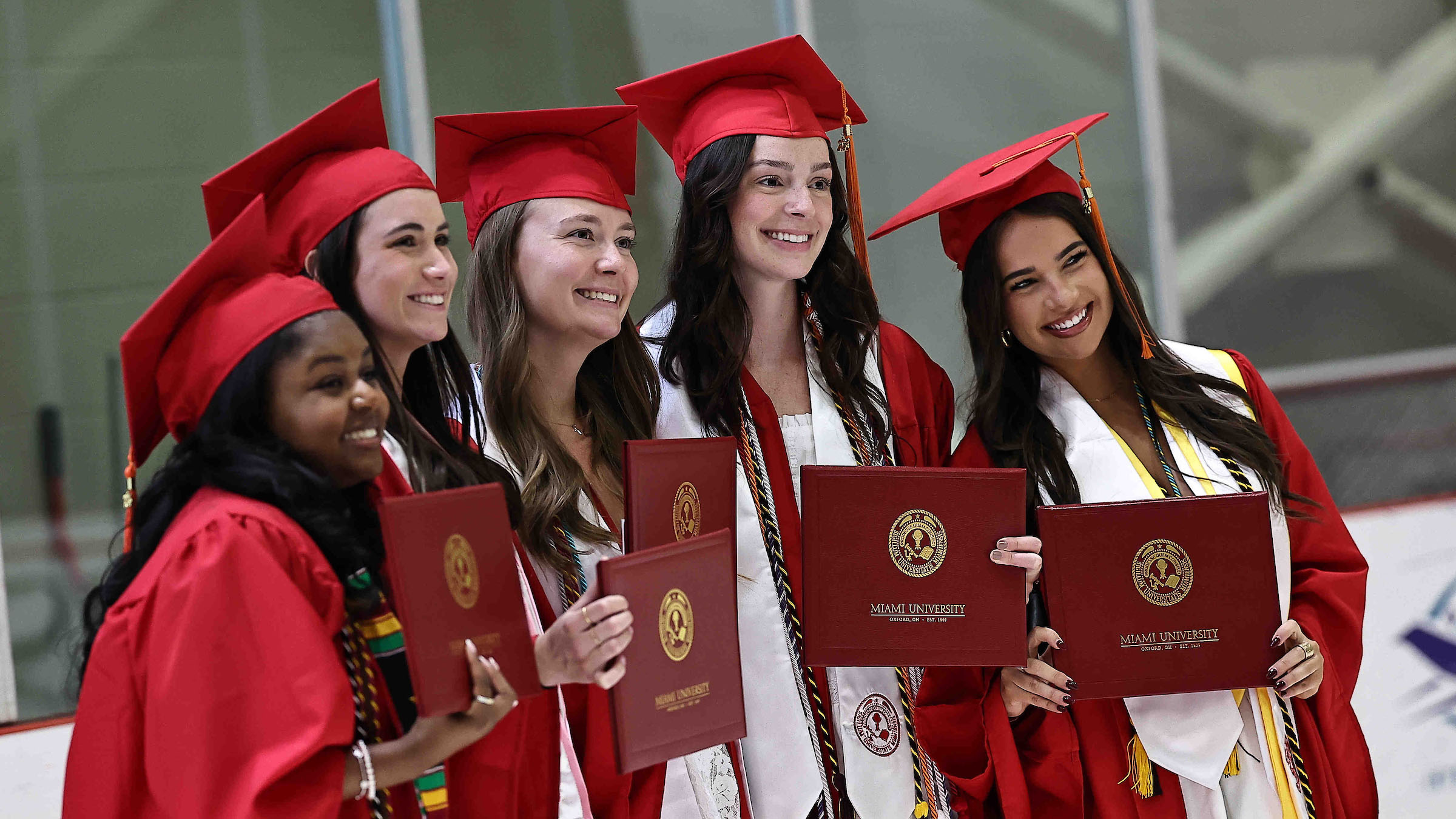 A group of graduates pose for a picture at a ceremony in the Goggin Ice Center.