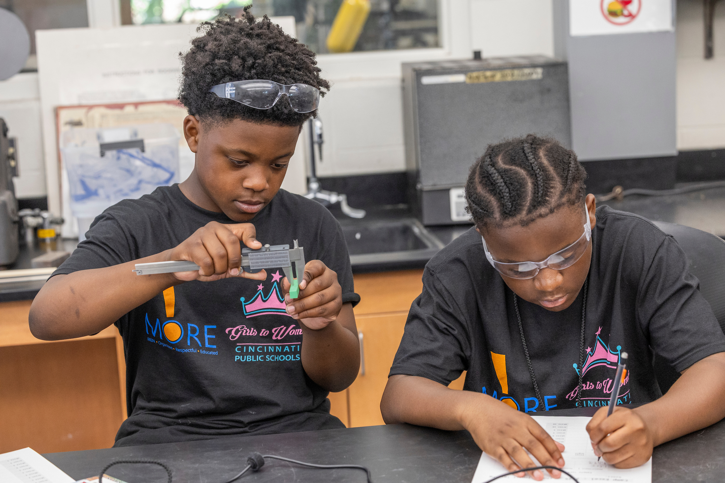 Two students work on a project in an engineering lab.