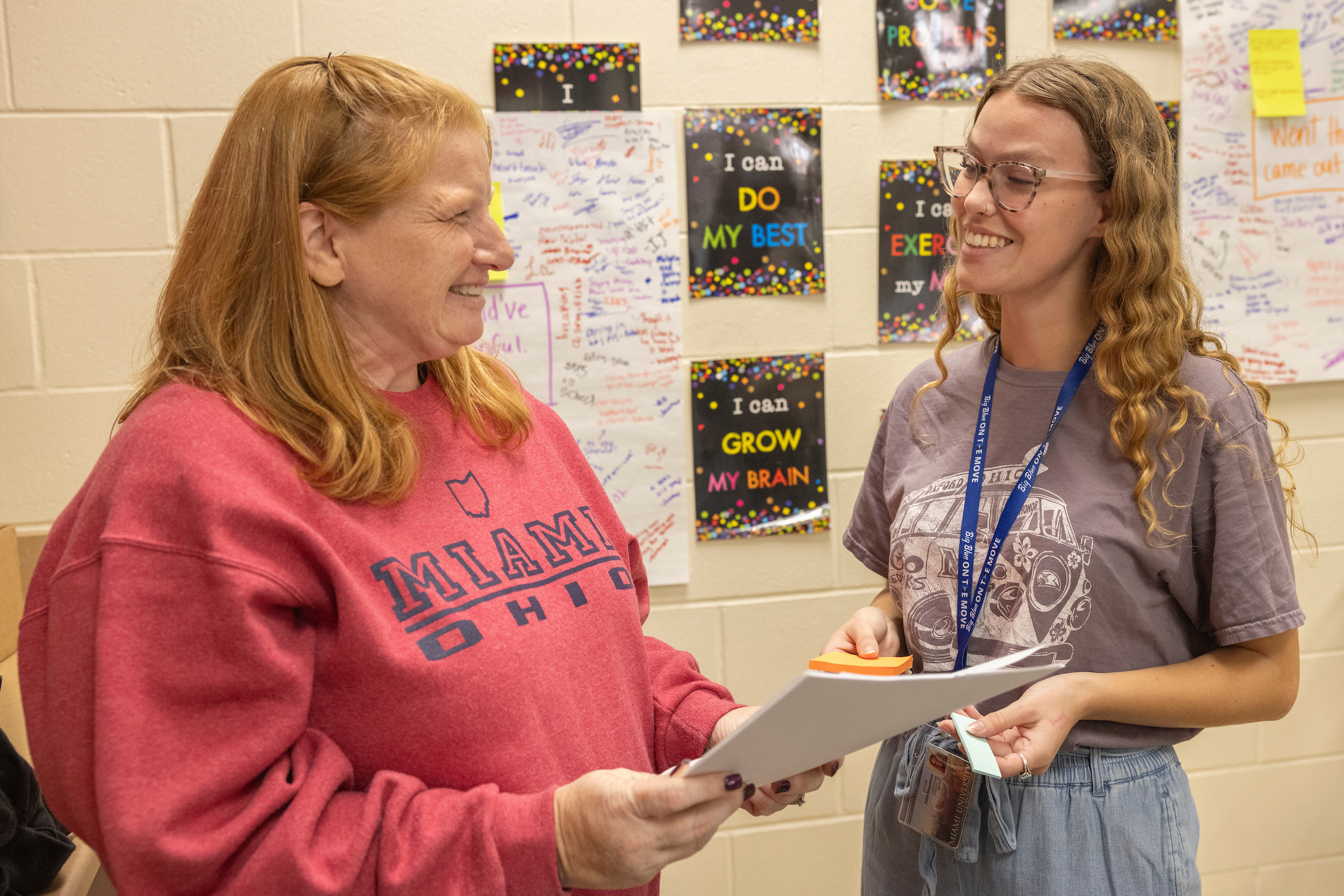 A student smiles while speaking with a Hamilton school district teacher.