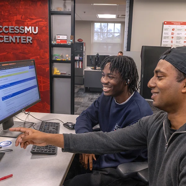 Two people working with accessible content on a computer screen.