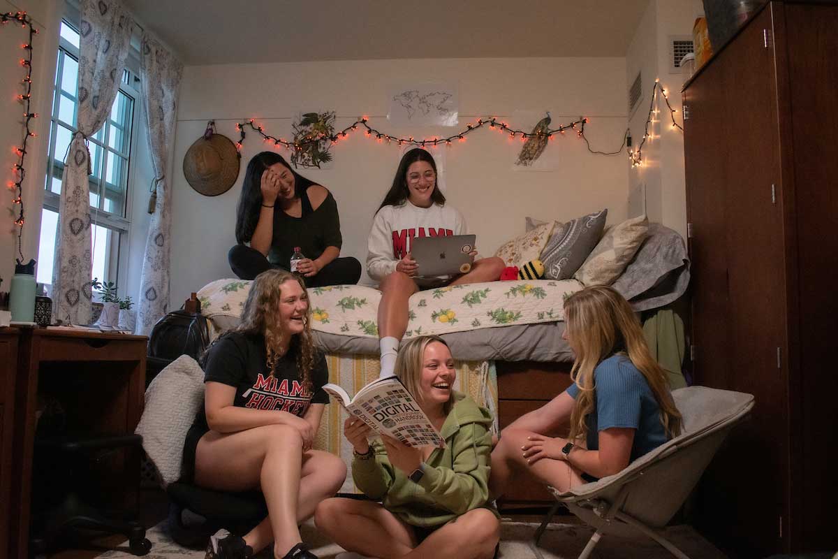 students gathered together in a dorm room
