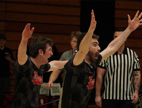 Miami University Club Dodgeball players Ty Keller, left, and Max Edling react to their team's 2-1 overtime win over the University of Cincinnati (photo by Kris Haas).