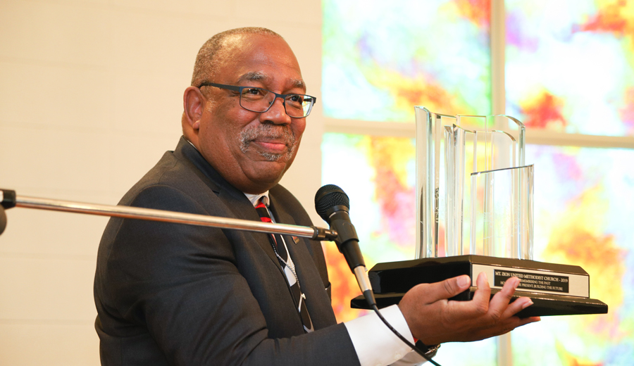 Ron Scott holding the Freedom Summer of ’64 Award