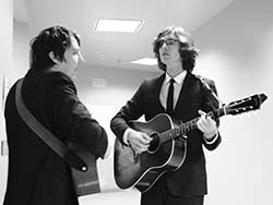 Black and white photo of The Milk Carton Kids playing