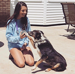 Picture of Staci Barrow with a dog.