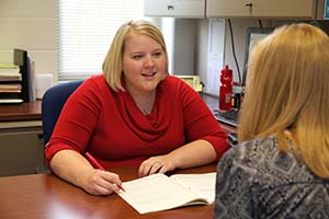 Senior Academic Advisor Christina Grote helping a female student