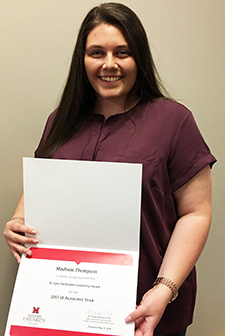 Photo of Madison Thompson holding 2017-18 W. Lynn Darbyshire Award