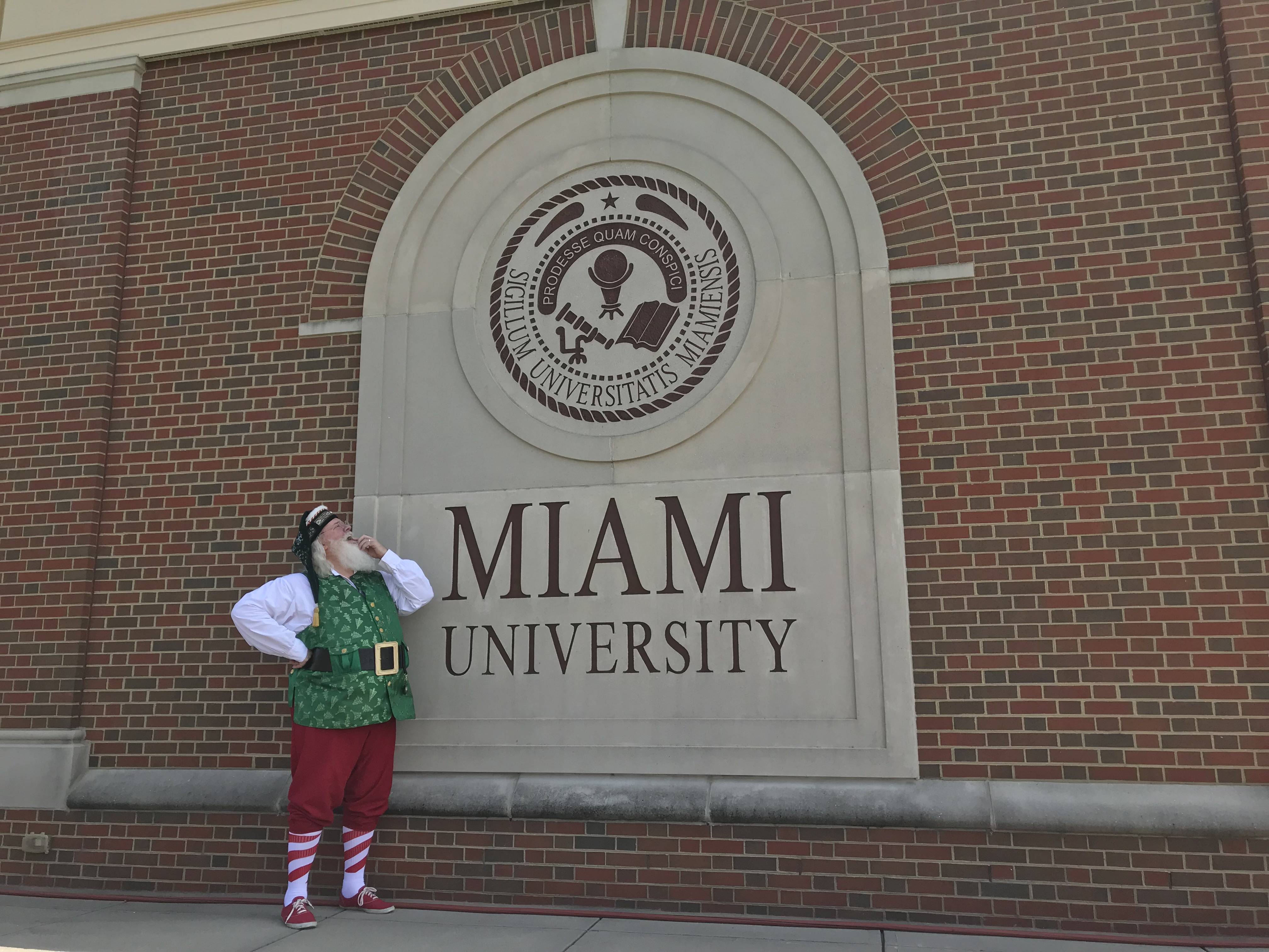 Photo of Santa in front of the Voice of America Learning Center sign.