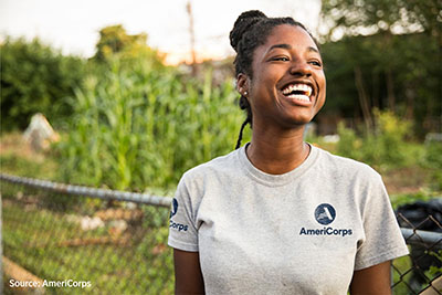 A photo of a girl outside with an AmeriCorps t-shirt