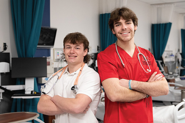 Brayden Osborne stands with Reed Stewart in the Nursing Lab at the Miami University Regionals campus in Hamilton.