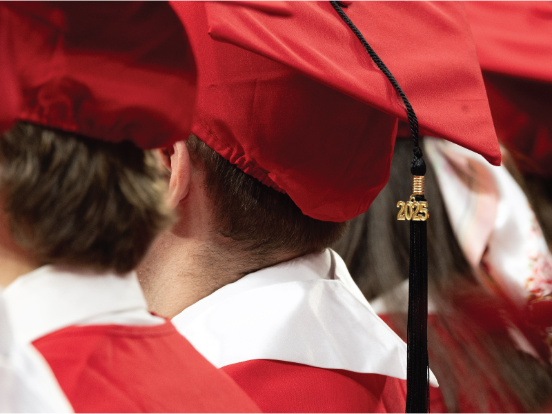 Red graduation cap and black tassle with a gold 2025 pendant