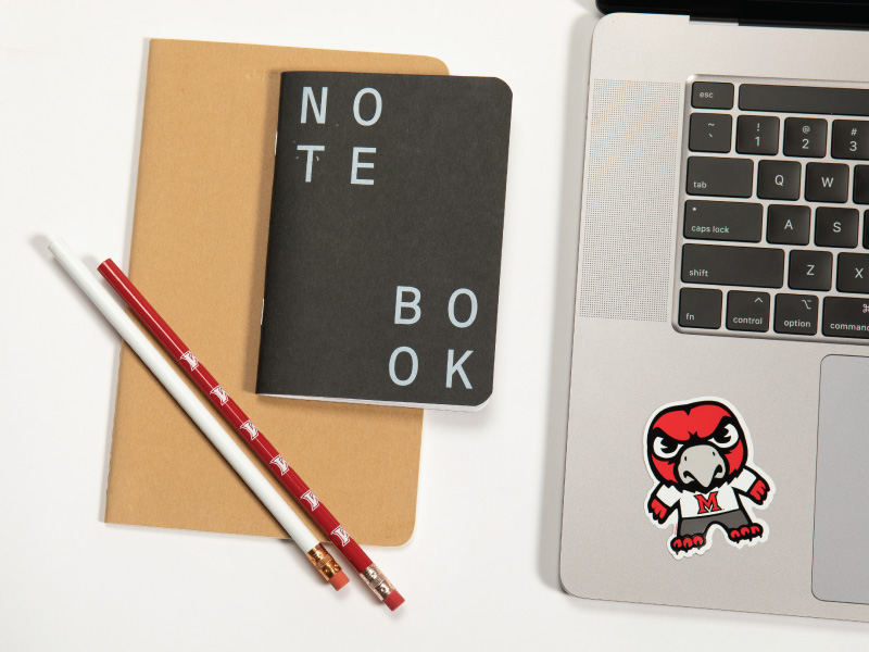 Notebook, pencils, and a laptop