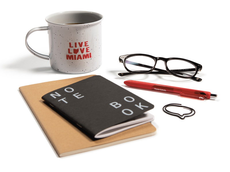 Notebook, pen, glasses and Miami coffee cup