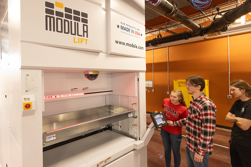 students working on a Modula LIFT machine