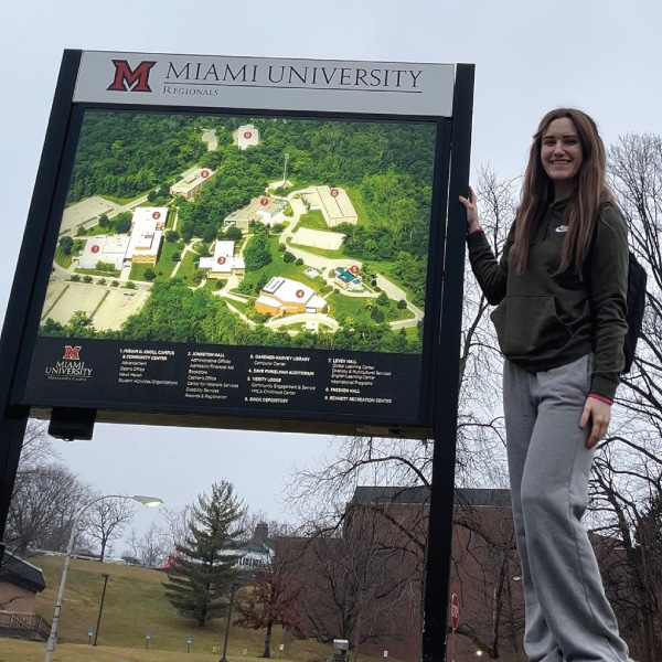 Katrina Borne standing near the directions map on the Middletown Campus.