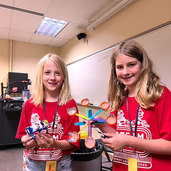 Two campers showing their amusement ride creations