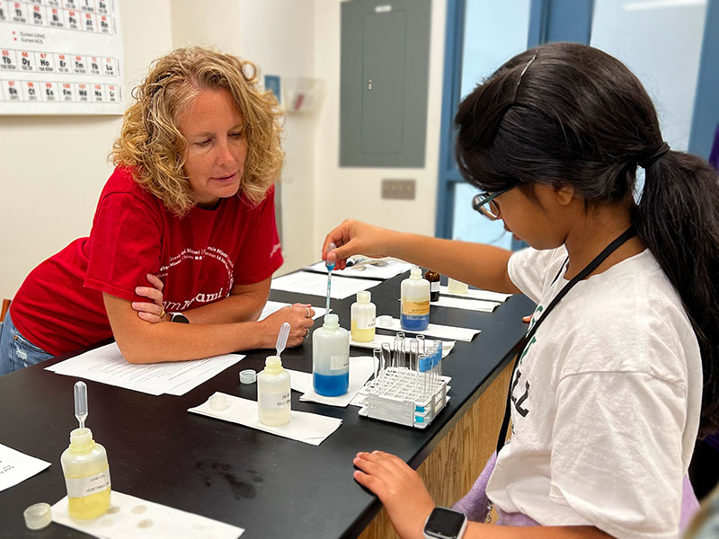 A STEAM Studio camper learning how to test chemical compounds with Miami faculty
