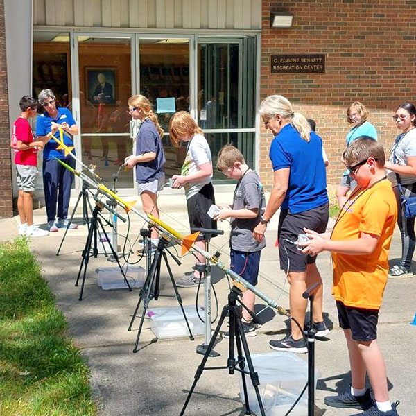 Campers preparing to launch model rockets