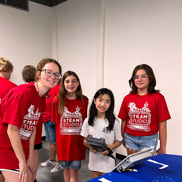 Young women connecting circuits