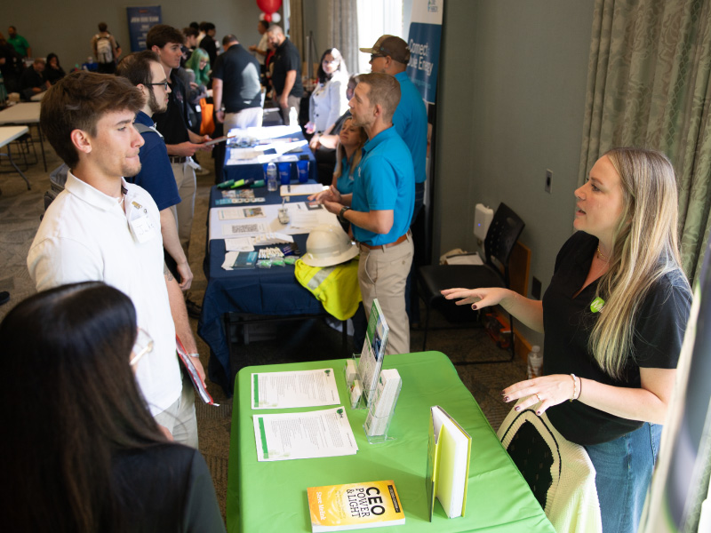2 students talking to an employer at the Career Fair.