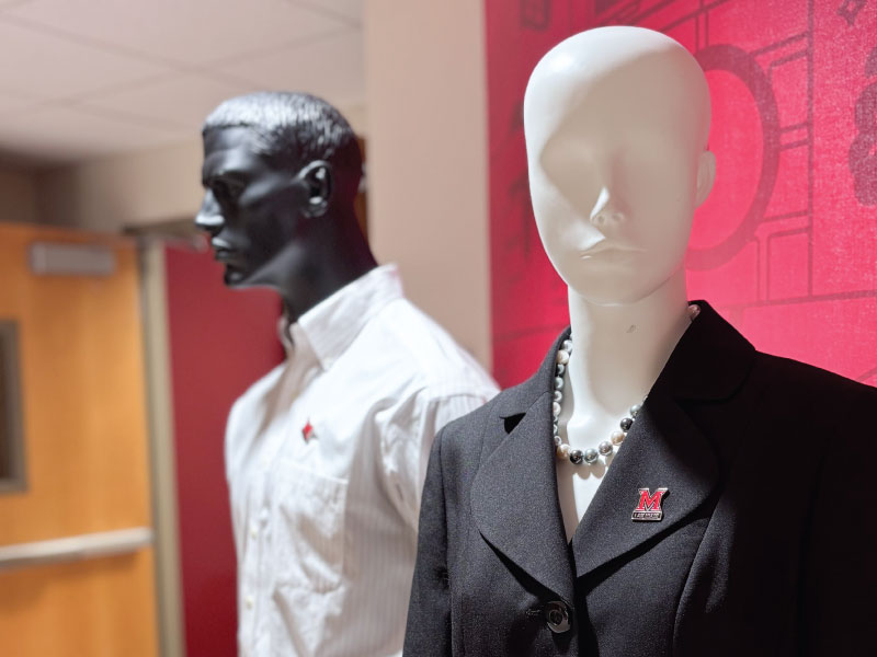 2 mannequins in business attire outside of the Career Services suite