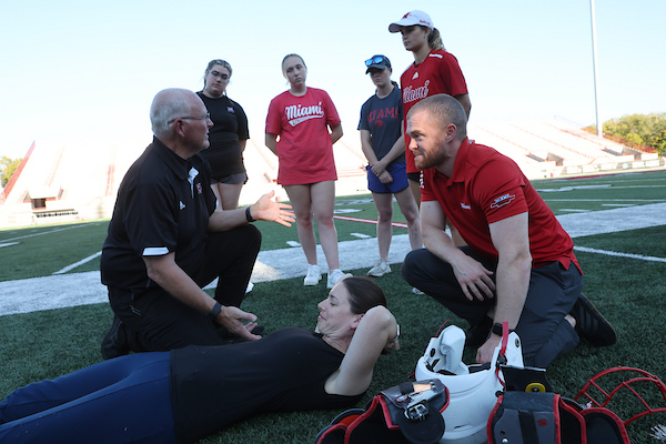 Athletic training professor and students at Yager Stadium. 