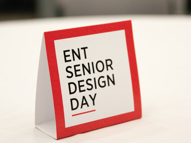 ENT Senior Design Day place card on a white tablecloth. 
