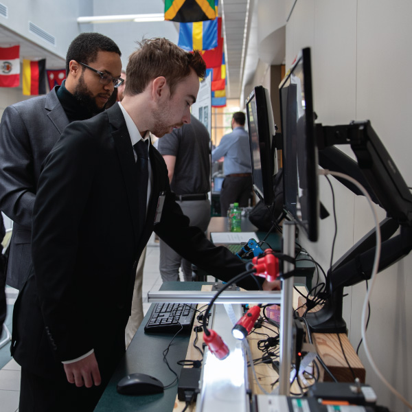 Student showcasing his Robot Arm with Machine Learning during Senior Design day.
