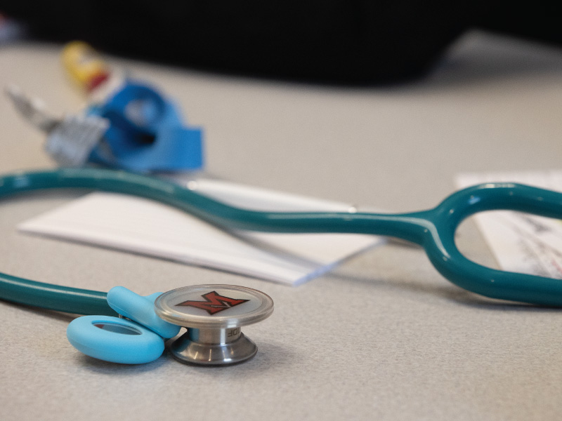 Stethoscope with a Miami M sitting on a table