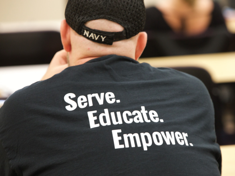 Student wearing a shirt that reads “Serve. Educate. Empower.”