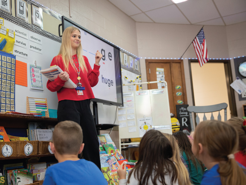 Education major Jessica Goodwin standing in front of a classroom of students teaching.