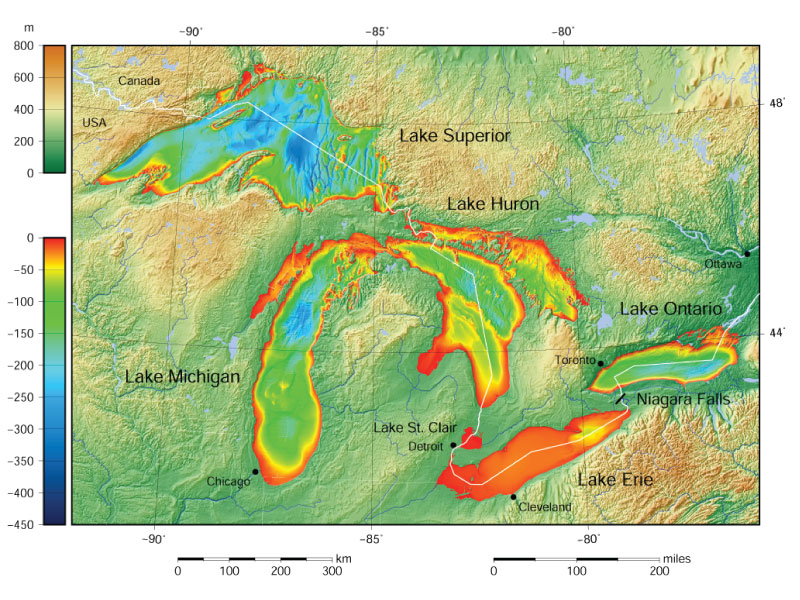 Topographic and bathymetric map of the Great Lakes showing labeled lakes, major cities, depth and elevation color scale, and waterways between lakes.